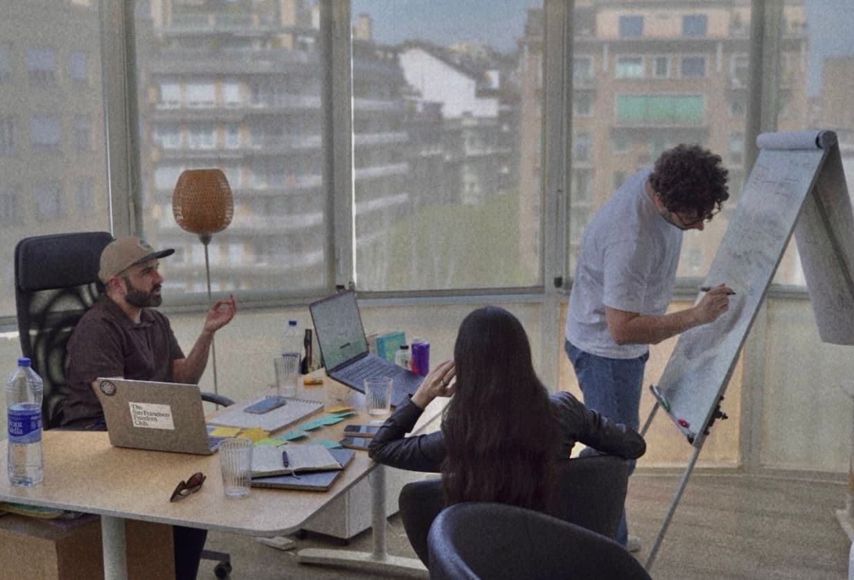 In-person Consul product workshop in Barcelona, with the team discussing ideas around a table and flip chart